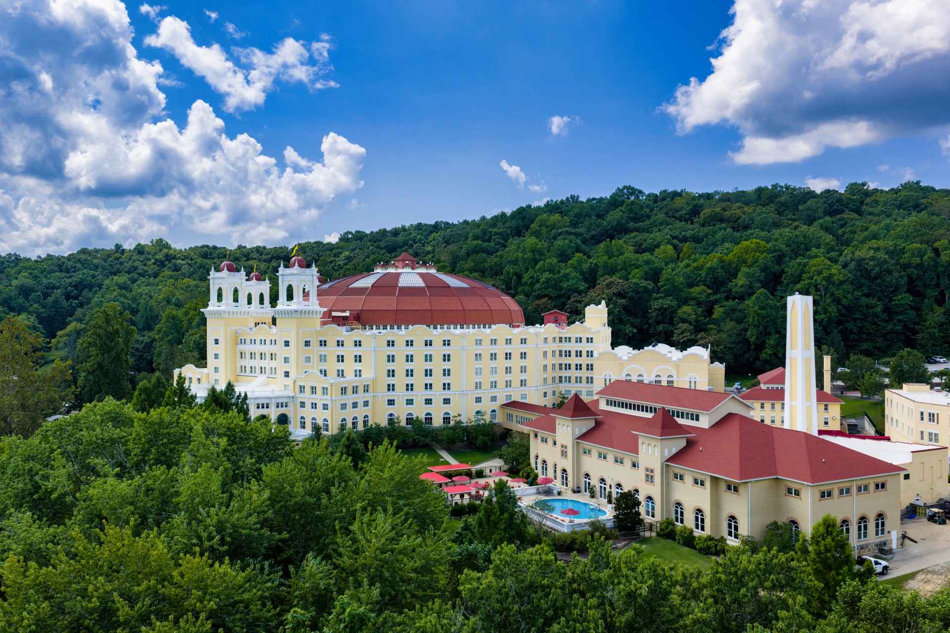 a large building with a pool in front of it