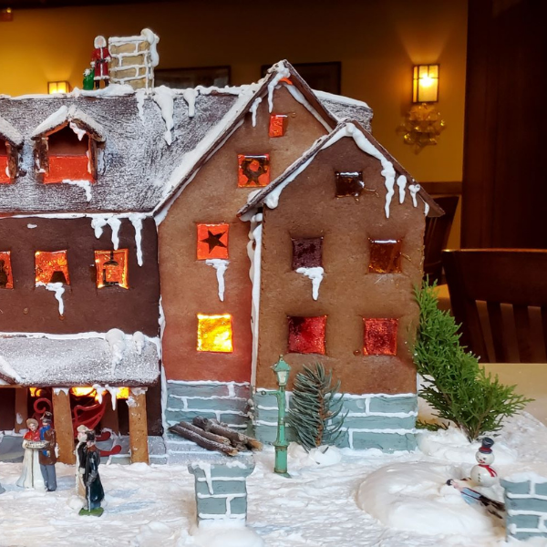 a gingerbread house with snow on it