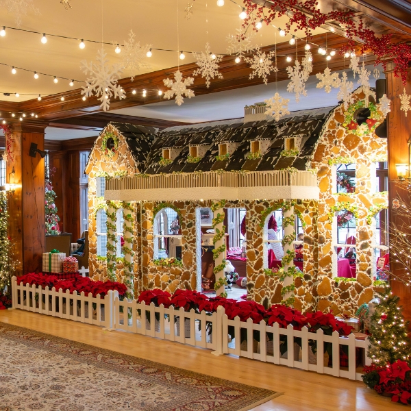 a room with a house and christmas decorations
