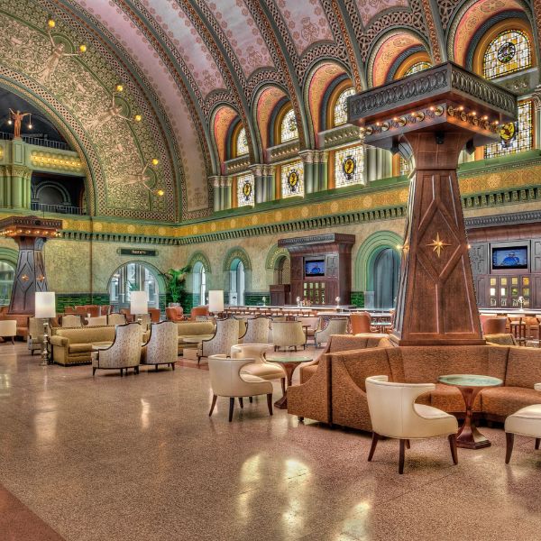 a large room with a large column and chairs