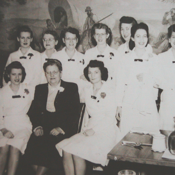 a group of women in white dresses