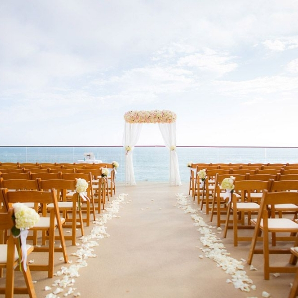a wedding ceremony set up with chairs and flowers