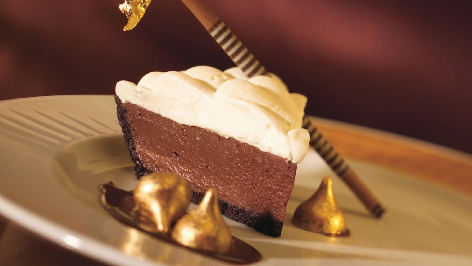 a piece of chocolate pie with a straw on top of it