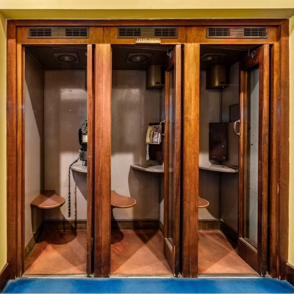 a telephone booth with glass doors