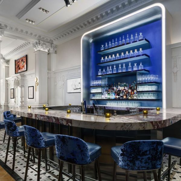 a bar with blue chairs and blue shelves