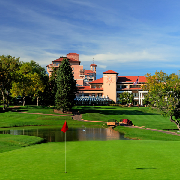 a golf course with a building in the background