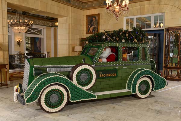 a man in a car decorated with a tree