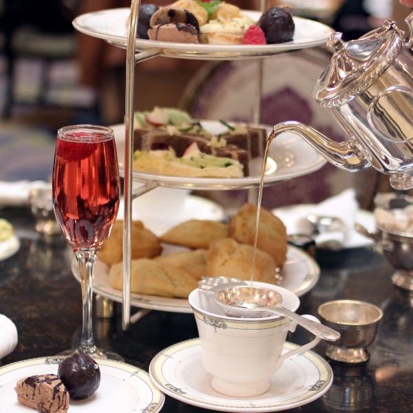 a tea set with food on plates and a teapot