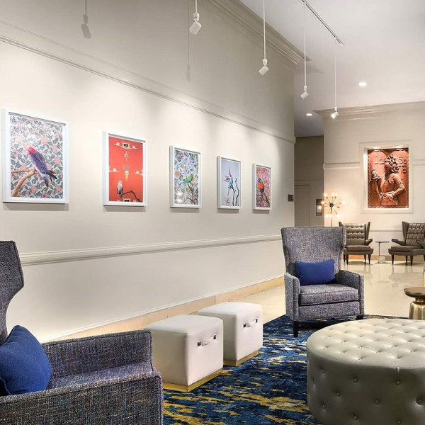 a room with chairs and art on the wall