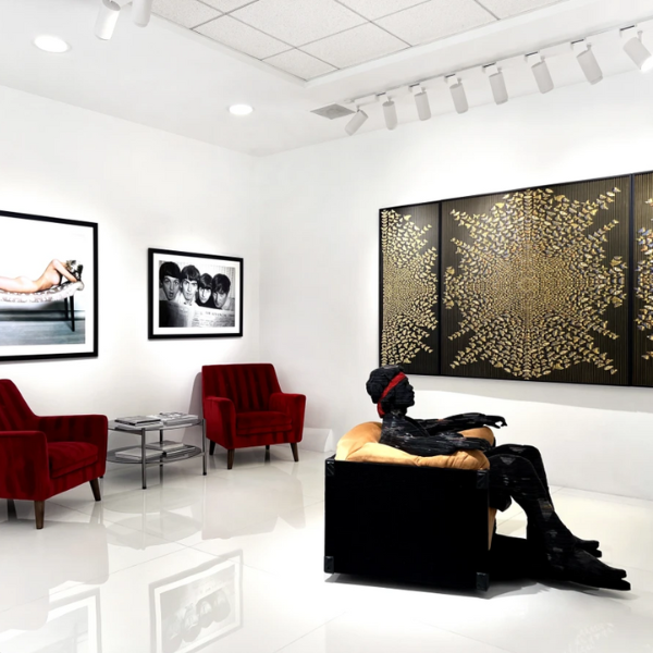 a room with a statue and red chairs