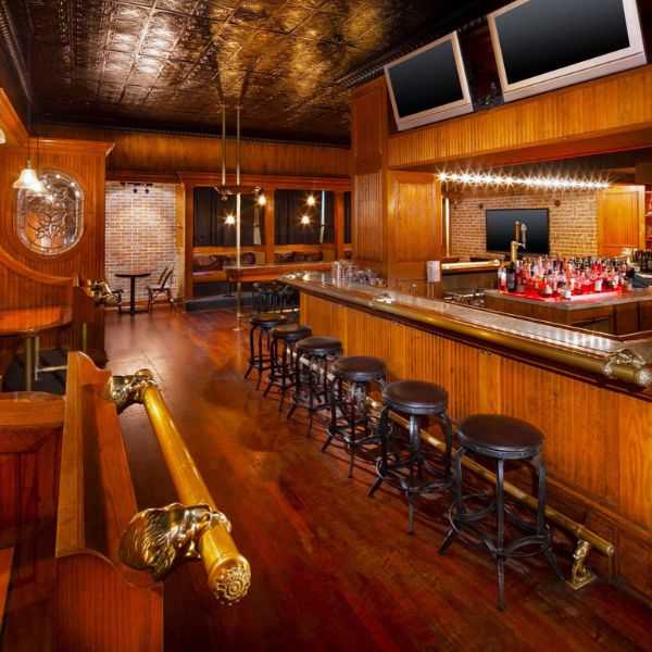 a bar with stools and a row of chairs