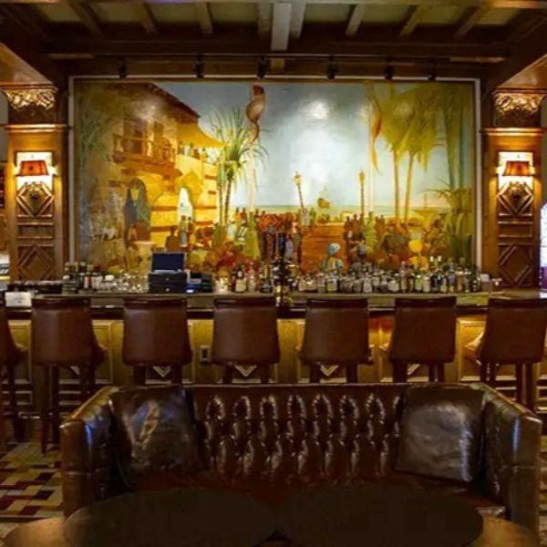a bar with a painting on the wall