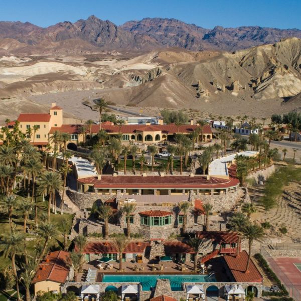 a resort with a pool and mountains in the background