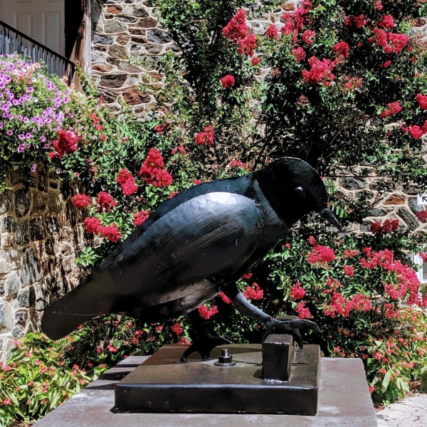 a statue of a bird on a pedestal