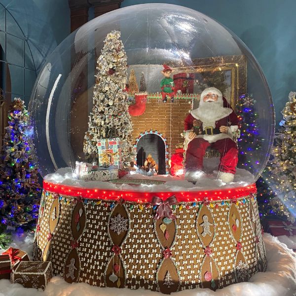 a snow globe with a santa claus sitting inside