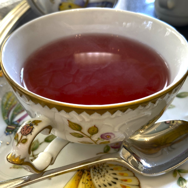 a cup of tea with red liquid
