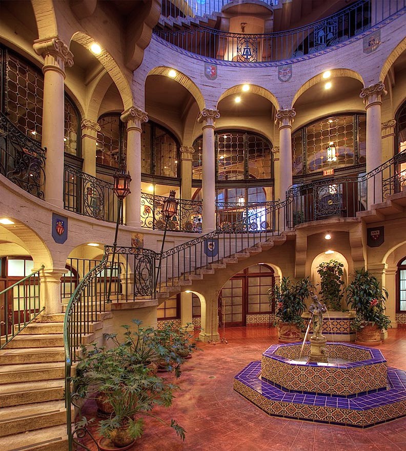 a large building with a fountain and stairs