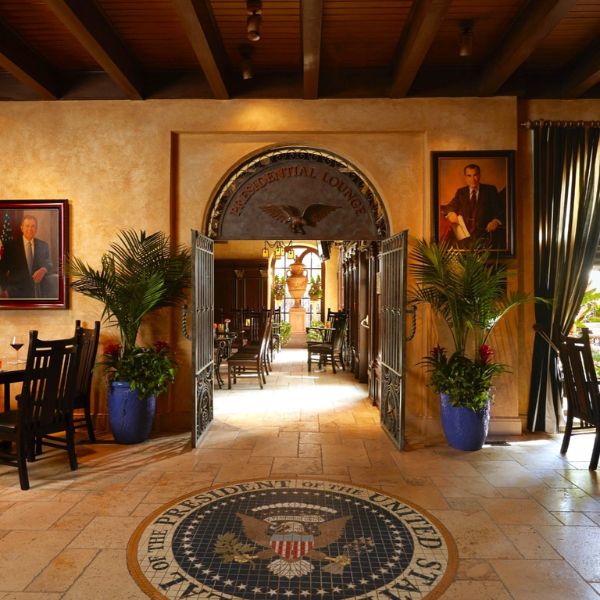 a room with a tile floor and a tile floor with a logo and plants