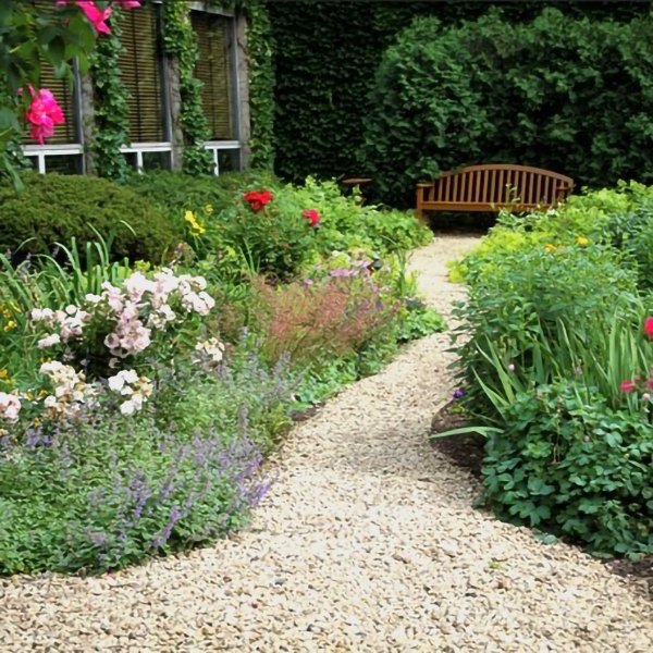a garden with a bench and flowers
