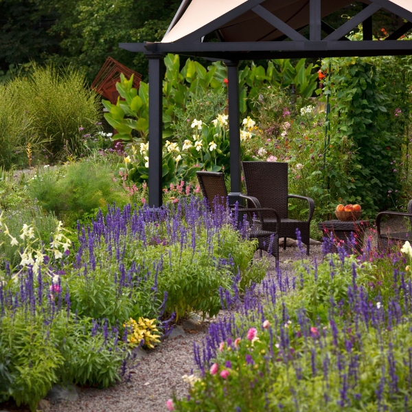 a garden with chairs and a gazebo