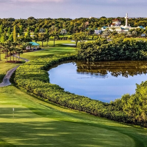 a golf course with a body of water