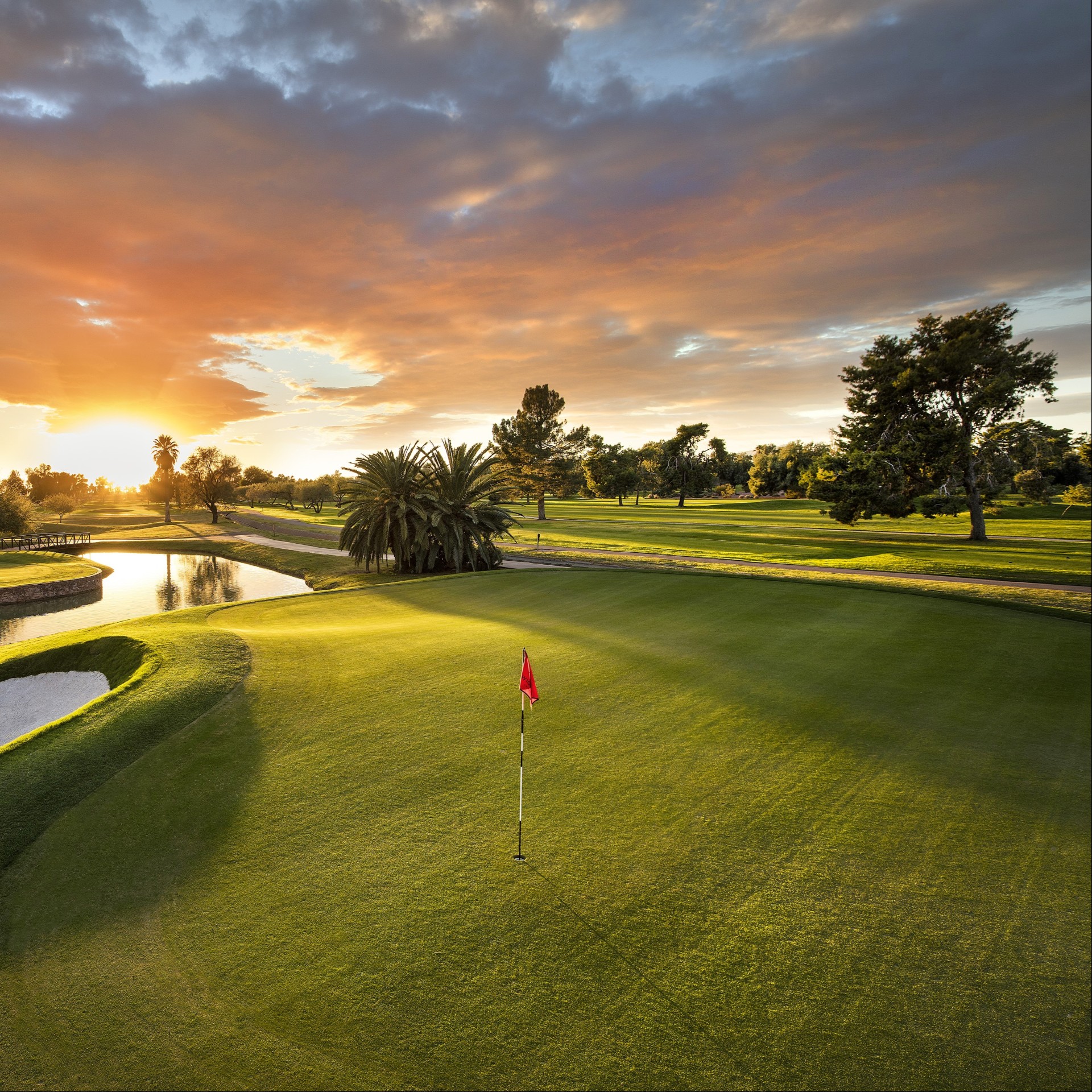 a golf course with a flag on the green