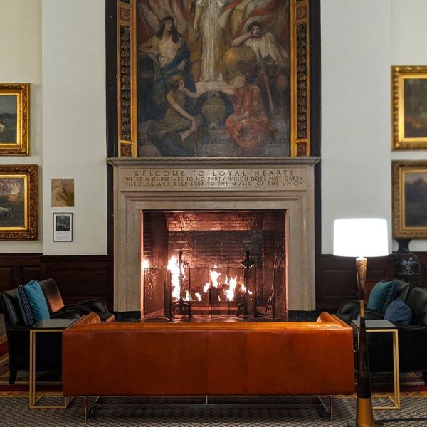 a fireplace in a room with art on the wall
