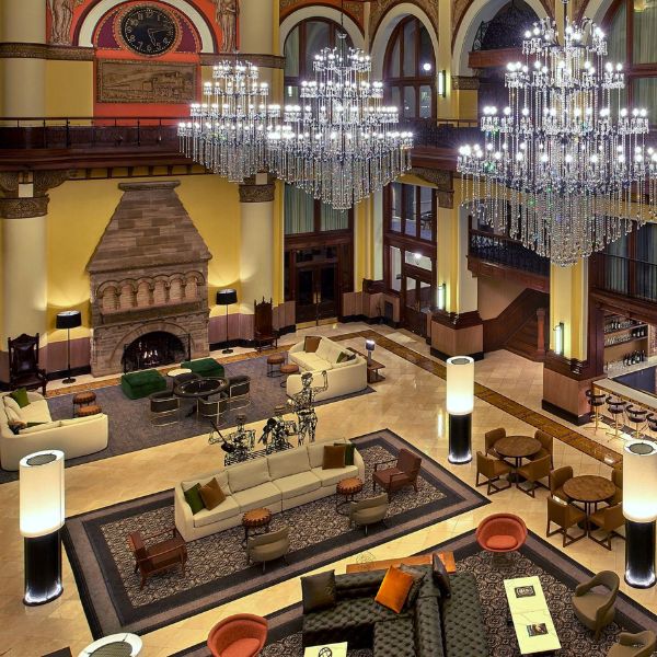 a large room with chandeliers and a fireplace