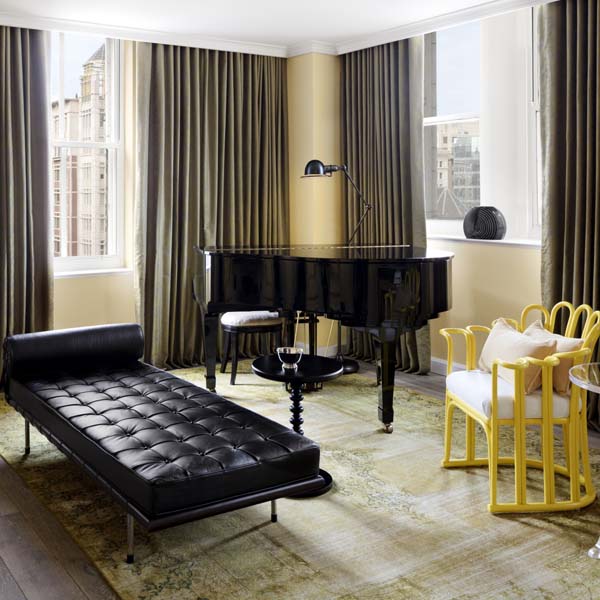 a room with a piano and chairs