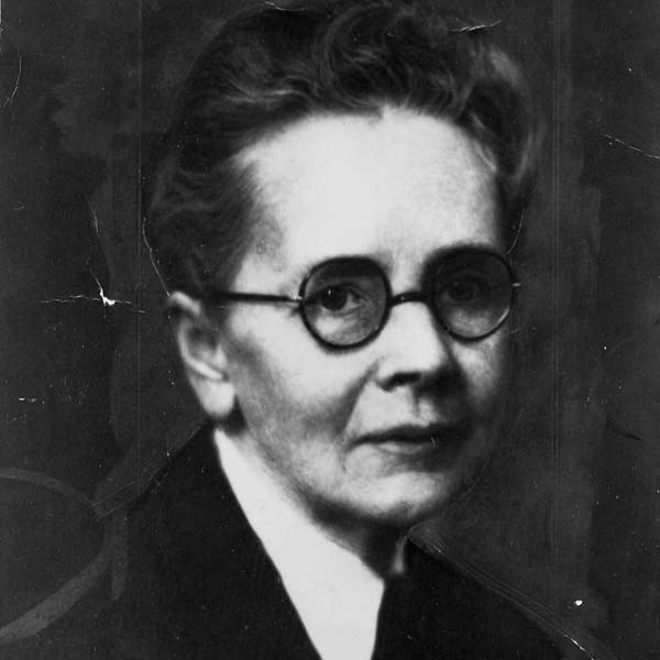a woman wearing glasses and a black shirt