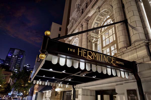 a hotel entrance with a sign