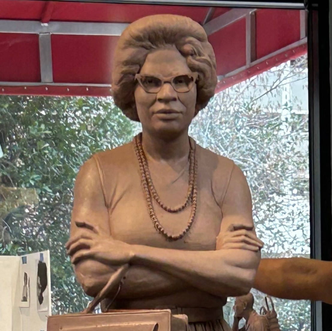 a statue of a woman with her arms crossed