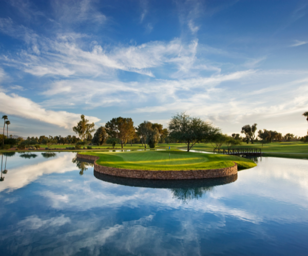 a golf course with a pond and a green island