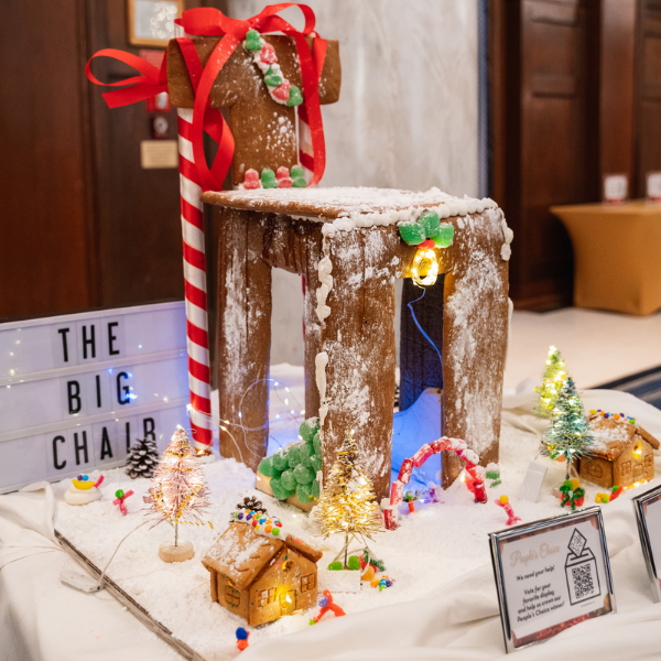 a gingerbread house with lights and candy canes