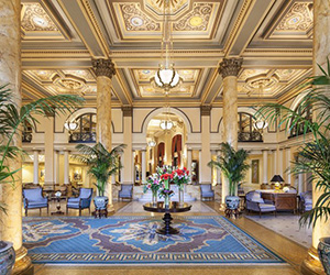 a lobby with a large round table and chairs