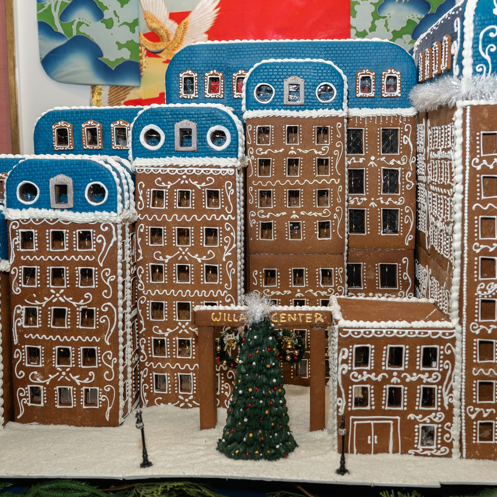a gingerbread city with a christmas tree