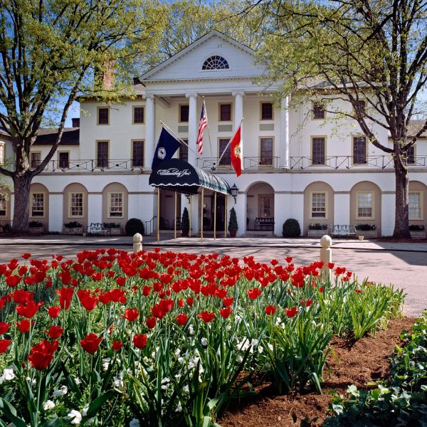 a white building with red flowers