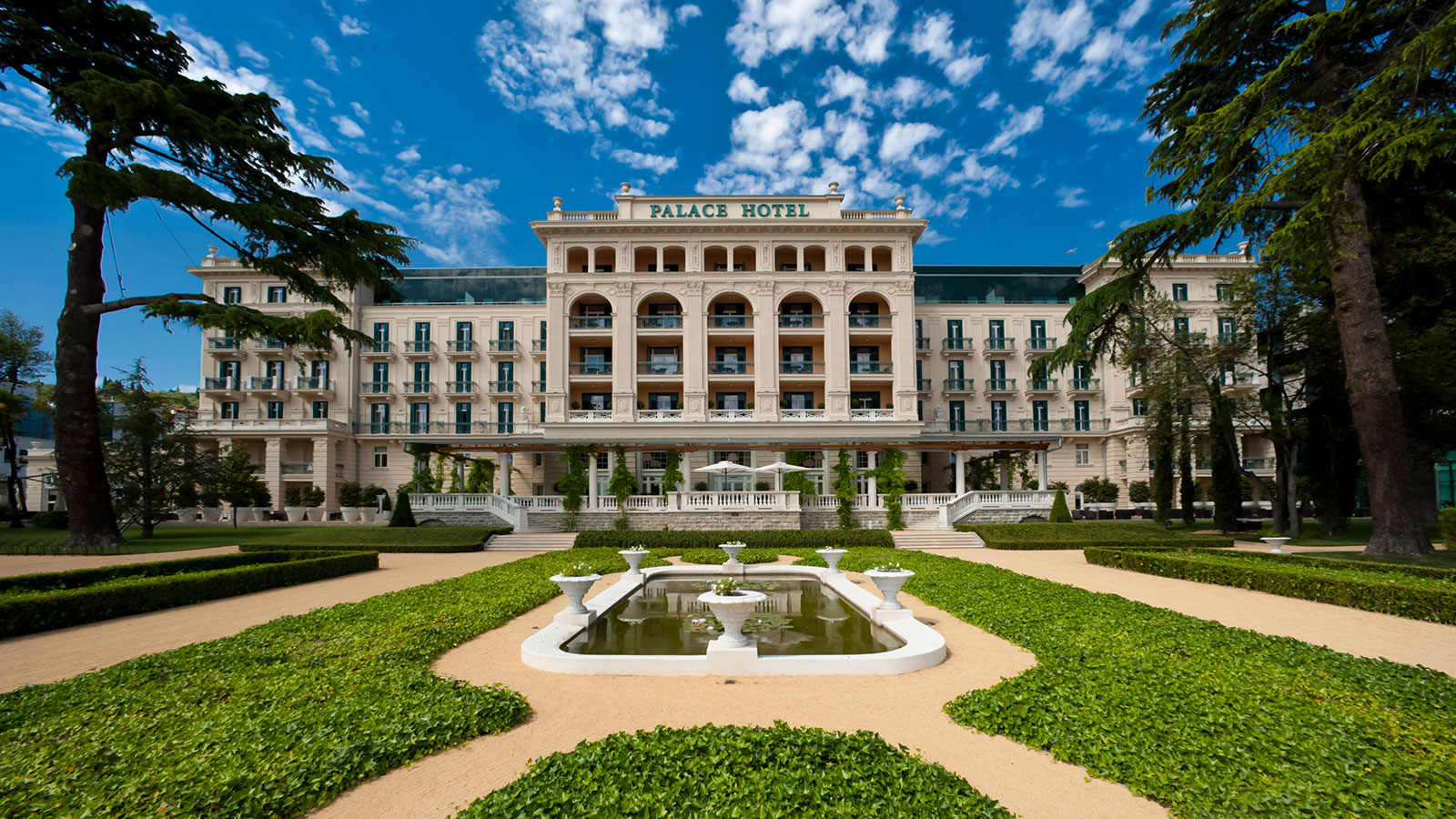 a large building with a fountain in front of it 3