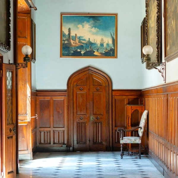 a room with a chair and a painting on the wall