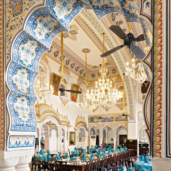 a room with ornate walls and chandeliers