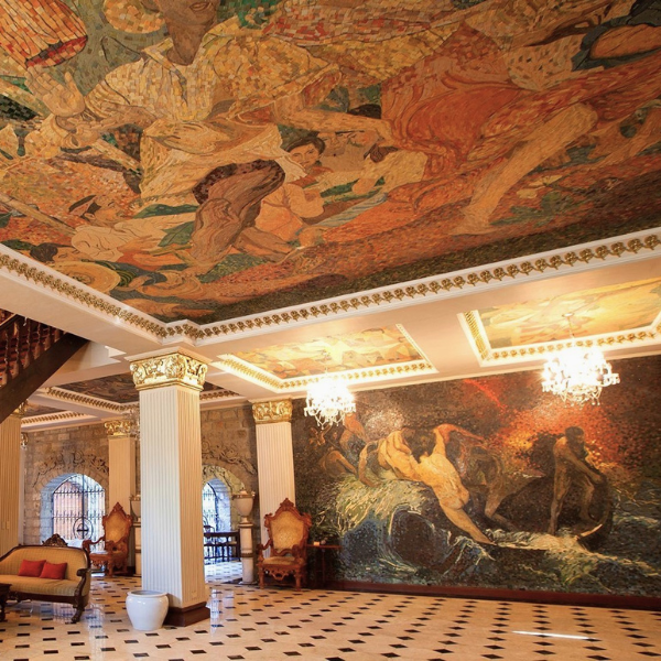 a room with a mosaic ceiling and a couch