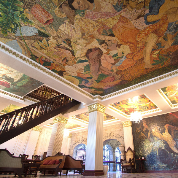 a large room with a mural on the ceiling