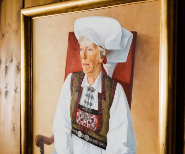 a painting of a woman in a gold frame
