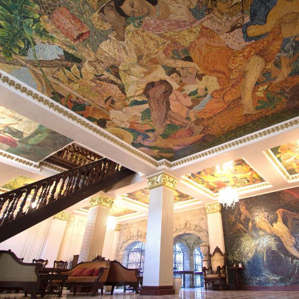 a room with a mural on the ceiling