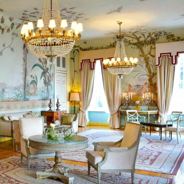 a room with a chandelier and chairs