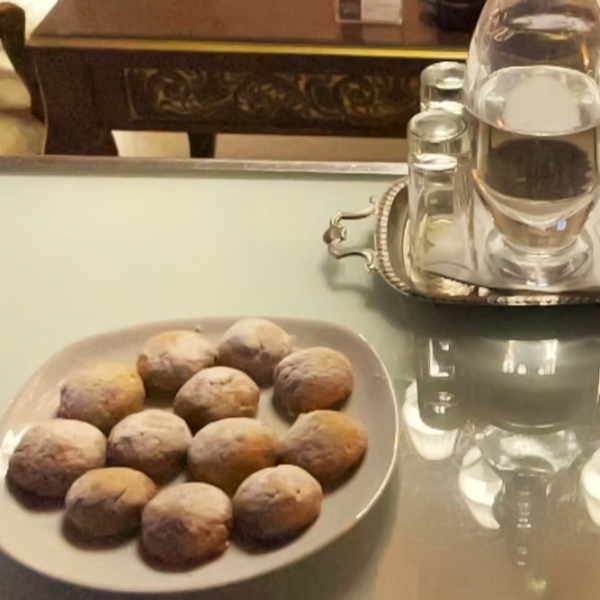 a plate of cookies and a glass of water on a table