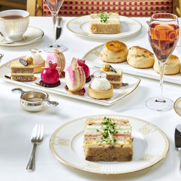 a table with plates of desserts and drinks