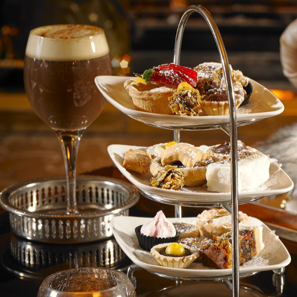 a three tiered tray with food on it
