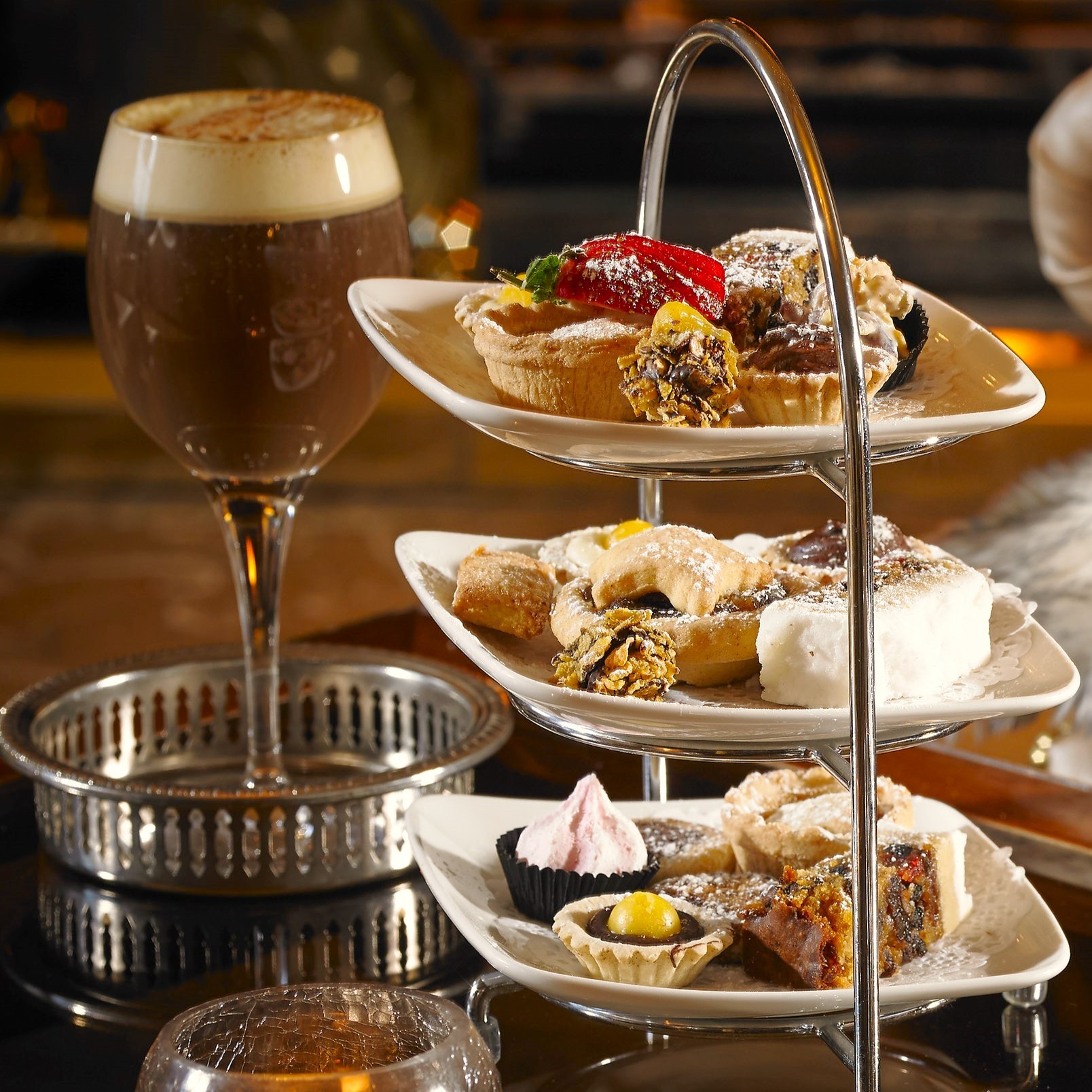 a three tiered tray with food on it