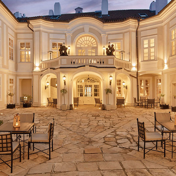 a large building with a patio and tables